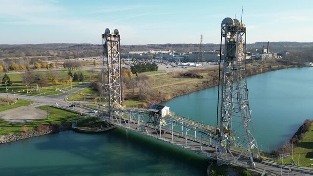 Circling aerial of the Glendale Avenue Bridge vertical lift bridge over the Welland Canal in St. Catharines, Ontario, Canada. Between locks 3 and 5. Autumn in November 2024.