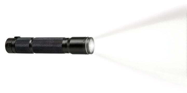 Portable LED flashlight emitting a bright beam of light during night exploration and security