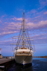 Fototapeta premium Gorch Fock Tall Ship Docked at Port with Dramatic Sunset Sky