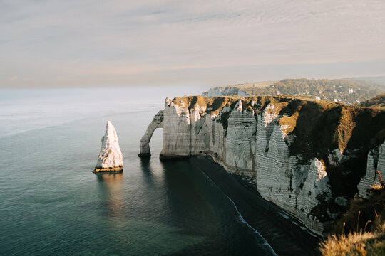 White chalk cliffs and natural stone arch at Etretat along the English Channel coastline in France