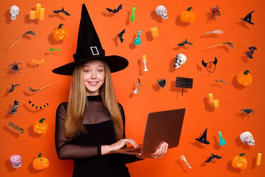 Photo of pretty sweet lady wear black wizard costume cap online shopping modern gadget empty space isolated orange color background