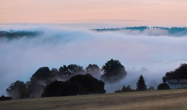 Tiefer dichter wei&szlig;er dicker Nebel liegt &uuml;ber den Ort im Tal und verh&uuml;llt die Landschaft in ein romantisches licht