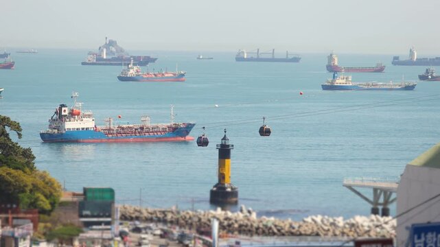 Busan Port and harbor of Busan, South Korea, container terminal with gantry cranes, cargo ships at anchor, shipyard docks, fishing boats and ferry terminal between Jung-gu, Nam-gu and Yeongdo island