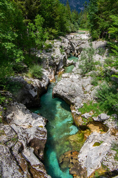 Amazing wild water in mala korita Soce valley, small pure clear turquoise flowing stream through stone gorge