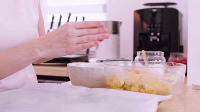 Homemade recipe. Cookies preparation. Woman chef hand shaping peanut ball dough pieces placing on culinary sheet with parchment paper.