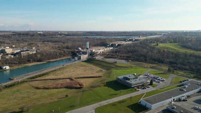 Aerial over the Welland Canal, part of the St. Lawrence Seaway in St. Catharines, Ontario, Canada. Thorold and Niagara Falls in the distance. Autumn in November 2024.