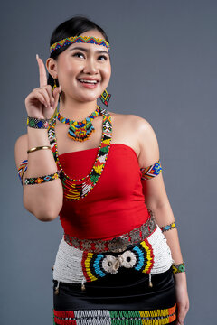 Portrait of young girl pointing finger up in traditional cloth Simba Murut Tahol native of Sabah Borneo