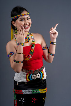 Portrait of young girl pointing finger right in traditional cloth Simba Murut Tahol native of Sabah Borneo