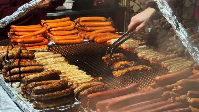 Grilling Traditional German Sausages and Bratwurst on BBQ Street Food Market