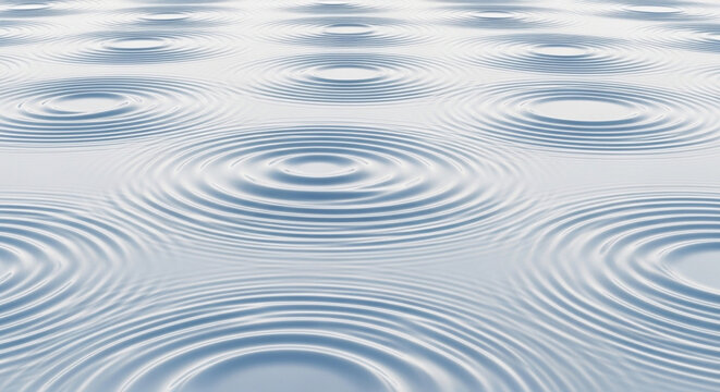 Multiple circular ripples expand across the calm liquid surface creating a serene pattern of concentric waves that move rhythmically throughout the frame to represent a peaceful sense