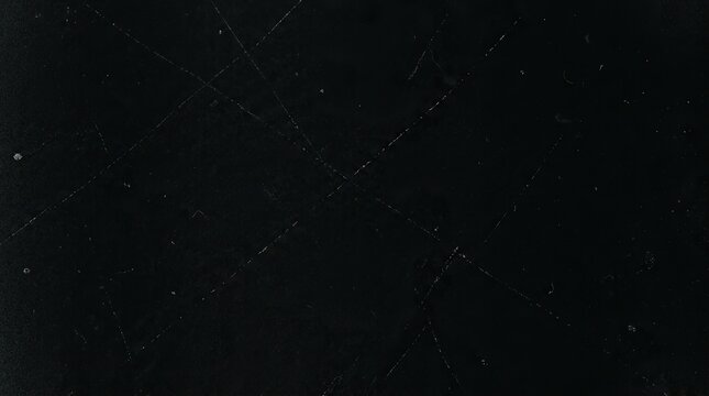 Abstract black background with subtle white scratches and dust texture overlay
