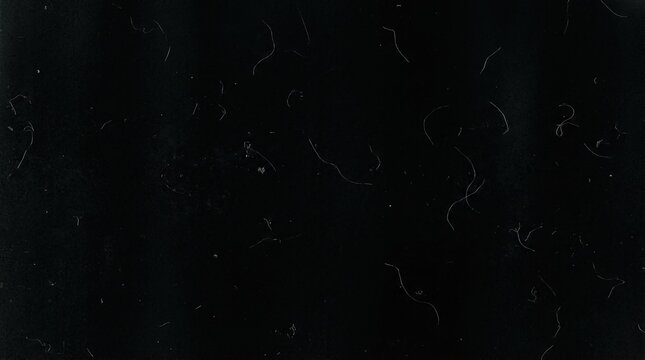 Vintage film texture with dust and scratches on black background