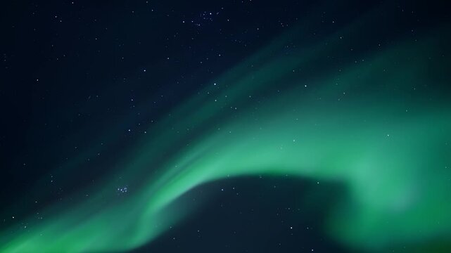 Aurora borealis ribbons moving across starry night sky with green and teal luminous curtains, sweeping flowing bands and soft cloudlike textures creating tranquil celestial panorama