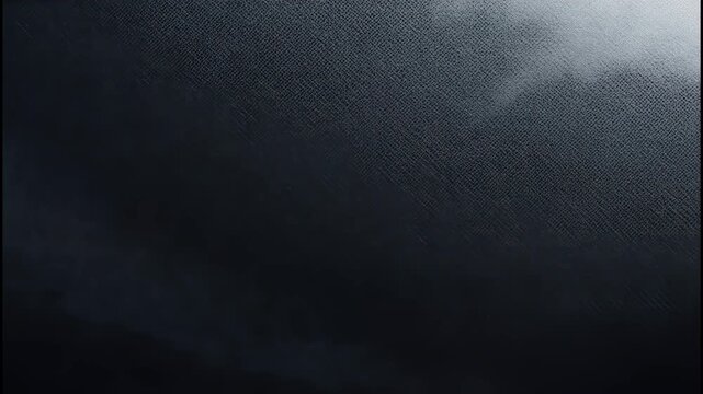 Dark black textured background with a subtle diagonal weave pattern and soft lighting 4k video