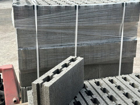 Packaged and stacked concrete hollow blocks on pallets