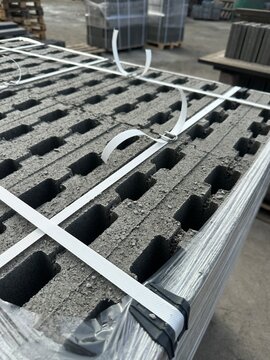 Packed pallet of concrete hollow blocks with plastic straps