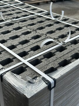 Strapped and wrapped pallet of concrete hollow blocks