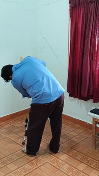 Young Man Mounting Video Camera onto Tripod Stand
