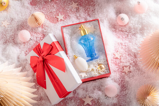 Classy fragrance flacon packaged inside sleek holiday box.