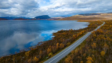 Scenic drone view of arctic road trip route in Kilpisjarvi Finland during autumn ruska season © Light&Lens
