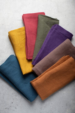 Overhead flat lay photograph of seven washed linen napkins