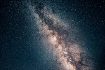 Fototapeta premium Milky Way band of stars and nebulosity stretching across the dark night sky. Astronomy and cosmos background