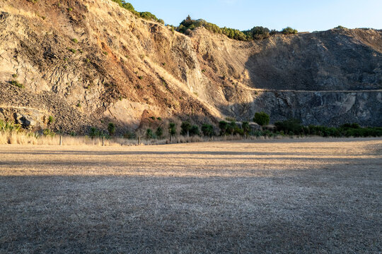 Road background, automotive backplate, large grassy open area with hills behind