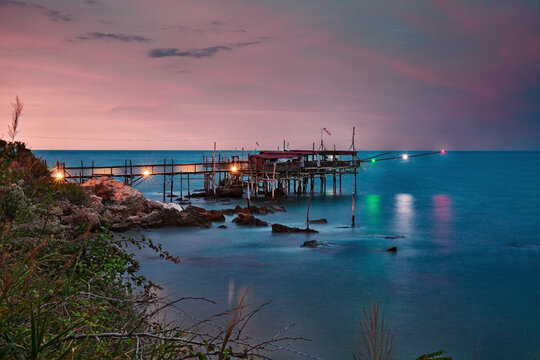 Abruzzo, Italy: Landscape of the Adriatic Sea coast at dusk with an old trabocco fishing hut, a traditional Mediterranean wooden pilework