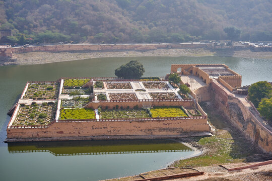Aerial view of the historic Kesar Kyari Bagh (Saffron Garden) situated on Maota Lake near Amber Fort in Jaipur, Rajasthan, India. The rectangular Mughal-style garden complex features intricate