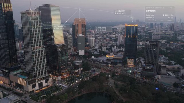 Aerial view of Bangkok at dusk: office towers and evening traffic beside Lumphini Park with glass interface overlay, city data card in baht and payment flow arcs. Concept of fintech, digital payments