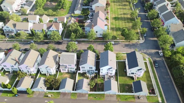 Detached garages line a rear alley behind houses in Leesburg Virginia aerial footage.