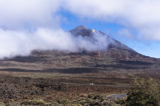 View of the Teide volcano from the Mirador de Juan Evora, with sun, blue sky and clouds. El Teide National Park, Tenerife, Canary Islands, Spain