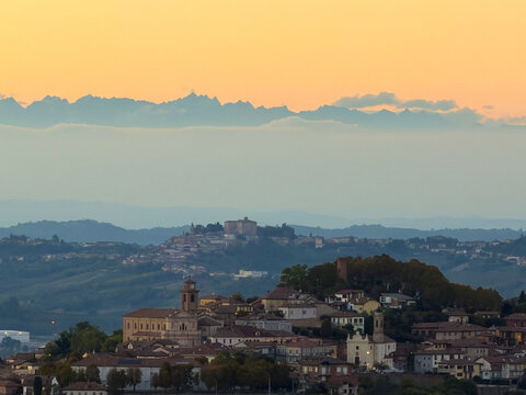 Beautiful sunset drone/scenic view over the rolling hills, green vineyards, and rural landscape of Castagnole delle Lanze, located in the Langhe and Monferrato wine region, Asti province, Piedmont, It