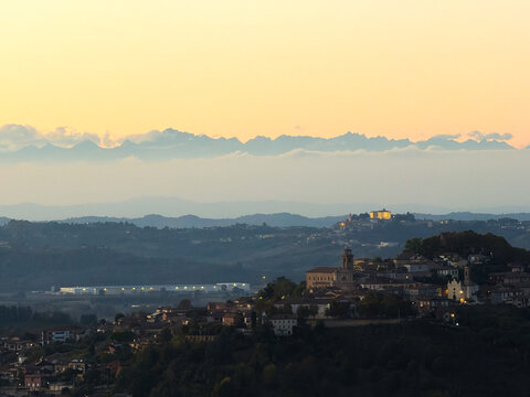 Beautiful sunset drone/scenic view over the rolling hills, green vineyards, and rural landscape of Castagnole delle Lanze, located in the Langhe and Monferrato wine region, Asti province, Piedmont, It
