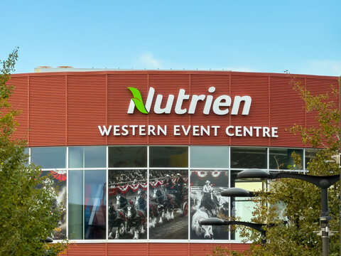 Calgary, Alberta, Canada. October 11, 2026. Exterior facade sign of Nutrien Western Event Centre framed by trees under blue sky.