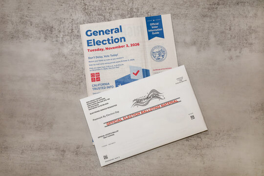 SAN DIEGO, CALIFORNIA ON OCTOBER 11, 2026. A flat lay view of the official State of California Voter Information Guide and a San Diego County official mail-in ballot envelope for General Election.
