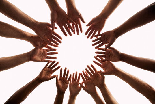 Diverse hands forming a circle symbolizing teamwork and unity