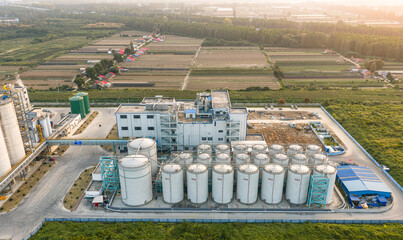 The Wuhan National Rice Trading Center, featuring modern bulk grain silos and conveyor belts in an aerial view, is a vital logistics hub ensuring national food security. © 晨啸 周