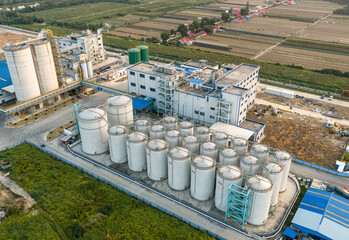The Wuhan National Rice Trading Center, featuring modern bulk grain silos and conveyor belts in an aerial view, is a vital logistics hub ensuring national food security. © 晨啸 周