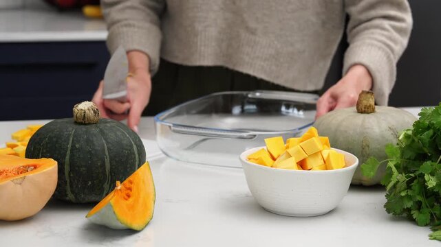 Engaging in the activity of chopping fresh and vibrant pumpkin for healthy cooking options