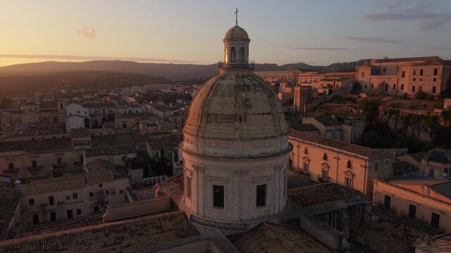 sunset flying counter clockwise around dome of Noto Cathedral in Sicily