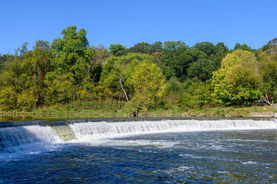 Water flows over a weir on the Humber River