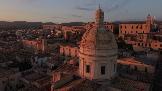 alt sunset flying counter clockwise around dome of Noto Cathedral in Sicily