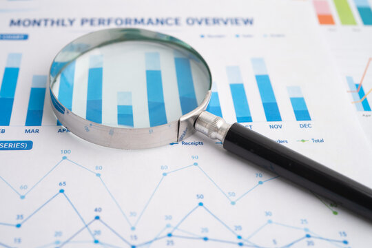 Magnifying glass on charts graphs paper. Financial development, Banking Account, Statistics, Investment Analytic research data economy.