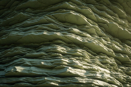 Layered slate rock strata in sage green and olive tones