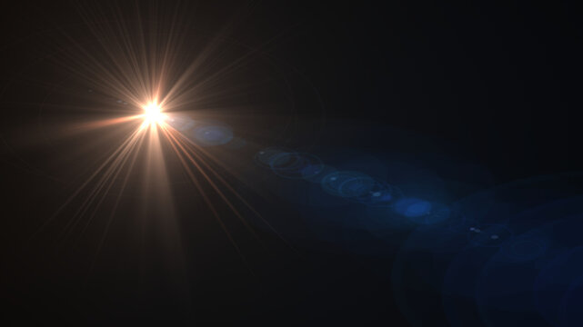 Bright golden orange starburst light with long rays and trailing blue circular lens flares on dark background