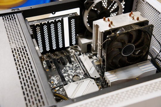 Computer case interior showing dirty cpu cooler and motherboard