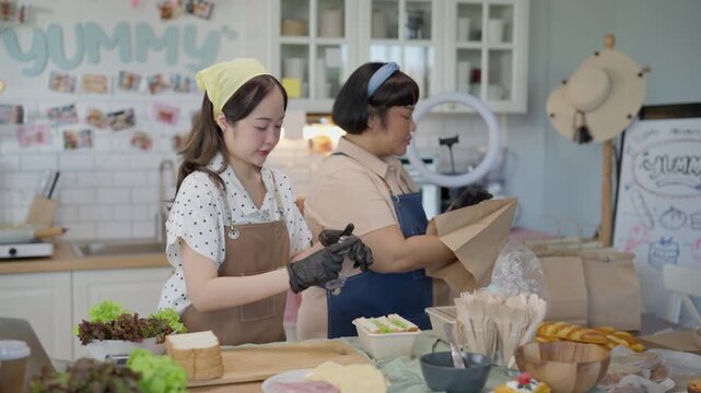 Cooking Baking Kitchen Live Streaming Online with Two Asian Women Preparing Fresh Bread Pastry Meals and Desserts for Cheerful Audience in Bright Home Studio Setting