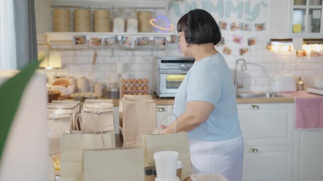 Cooking Baking Kitchen Live Streaming Online Woman Chef in Apron Preparing Packaged Food in Bright Home Kitchen for Cheerful Presentation and Small Business Sale