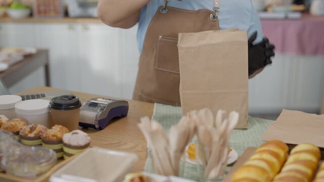Cooking Baking Kitchen Live Streaming Online Payment Preparation with Gloved Worker Packaging Pastries and Takeaway Food in Cozy Cafe for Warm Customer Service and Safe Food Handling